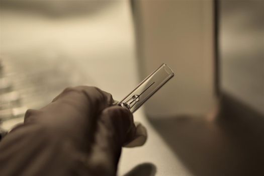close-up of a hand holding an injection