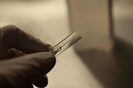 close-up of a hand holding an injection