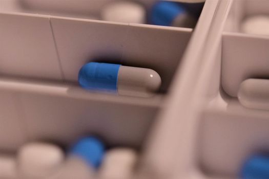 Close-up of different pills prepared in tablets boxes