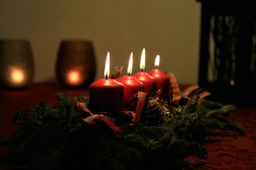 close-up of an Advent arrangement with 4 burning candles