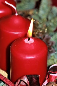 close-up of an Advent arrangement with 1 burning candle