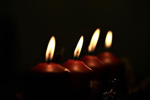 close-up of an Advent arrangement with 4 burning candles