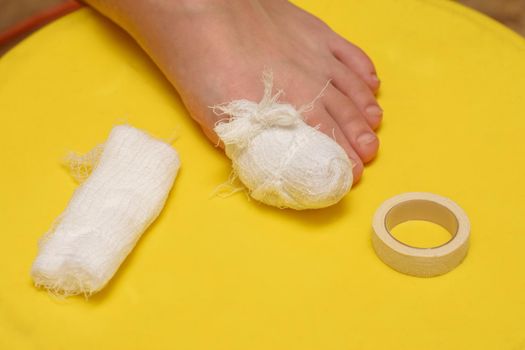 Bandage your big toe, there is a bandage and an adhesive plaster nearby