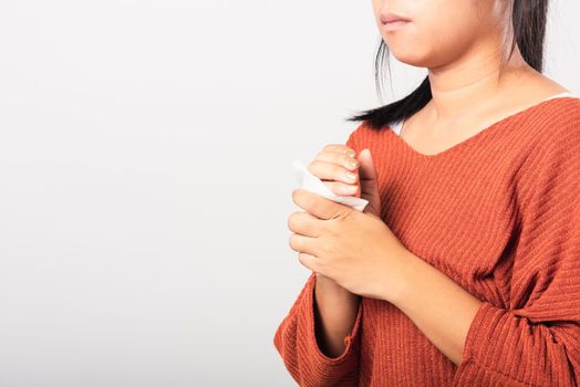 Close up hand of Asian woman she using wet tissue paper wipe cleaning her hands, studio shot isolated on white background, Healthcare medicine body care concept