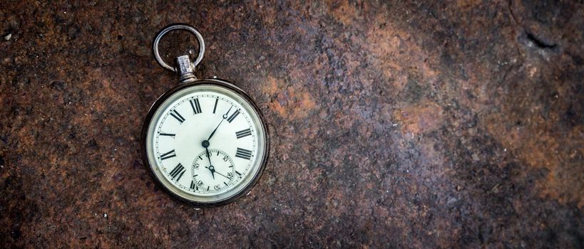 Vintage watch lies on a wood board, autumn time