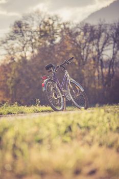 Parked bicycle on a field, autumn time