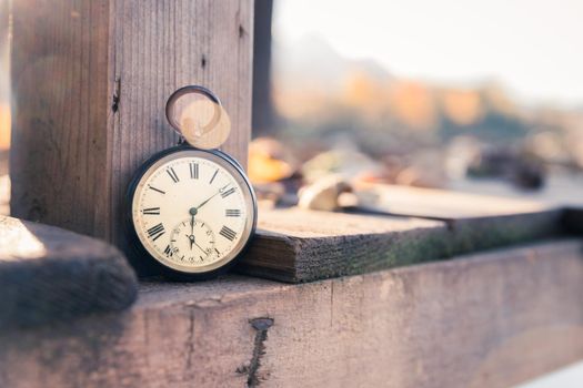 Hand held stop watch outdoors, autumn, blurry background