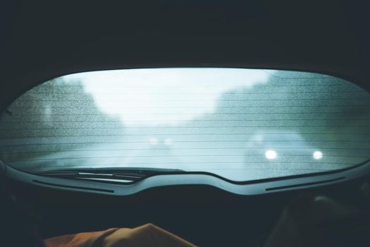 Back window of a car, rainy day, darkness