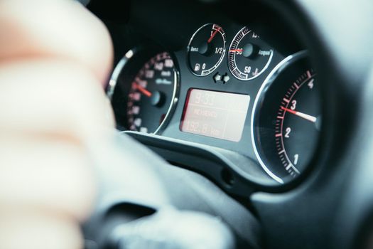 Female hands on a sports car steering wheel, car interior