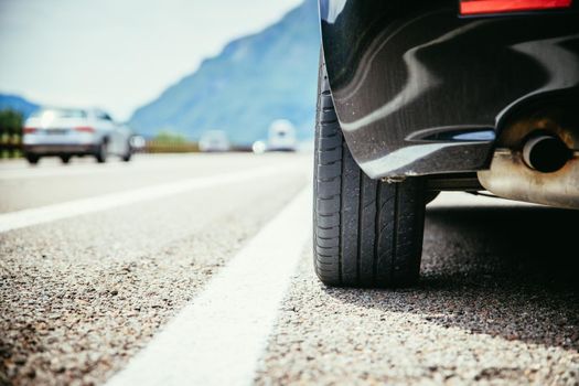 Close up of a car standing on a breakdown lane, summer vacation