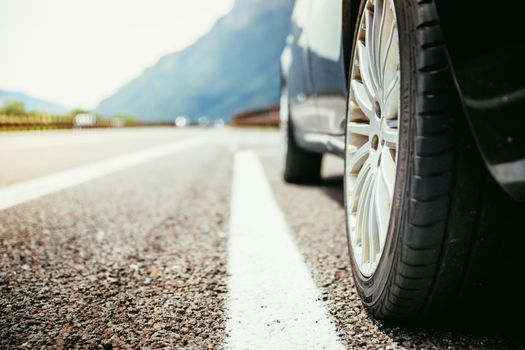 Close up of a car standing on a breakdown lane, summer vacation