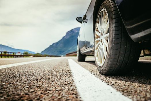 Close up of a car standing on a breakdown lane, summer vacation