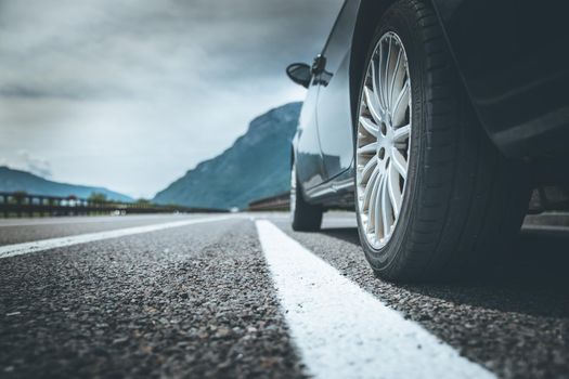 Close up of a car standing on a breakdown lane, summer vacation