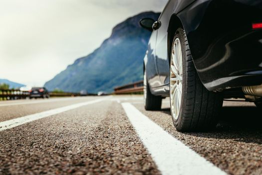 Close up of a car standing on a breakdown lane, summer vacation