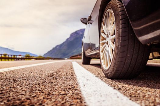 Close up of a car standing on a breakdown lane, summer vacation