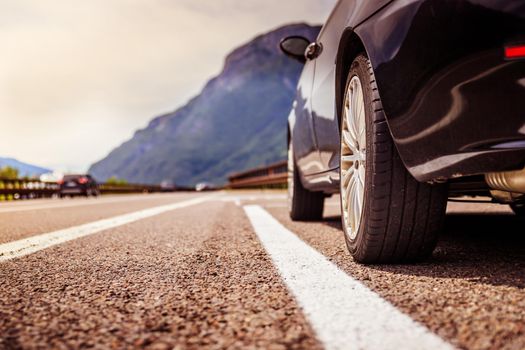 Close up of a car standing on a breakdown lane, summer vacation
