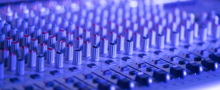 Professional music production in a sound recording studio, mixer desk