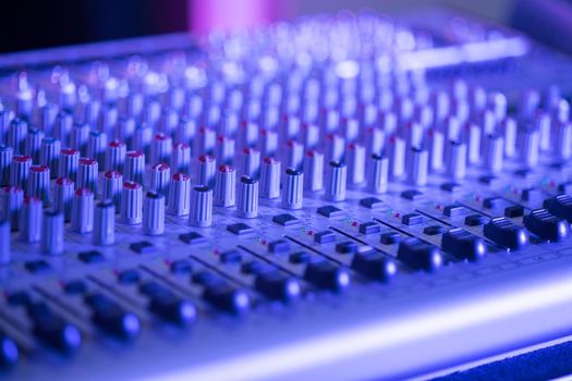 Professional music production in a sound recording studio, mixer desk
