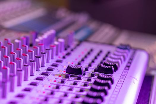 Professional music production in a sound recording studio, mixer desk