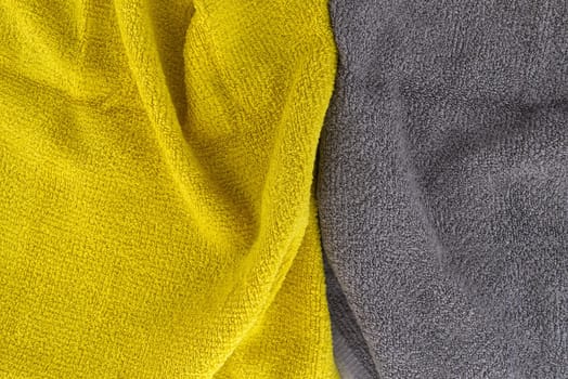 Two tone grey and yellow frote textile background with copy space viewed as a flat lay. Main color trend of the year