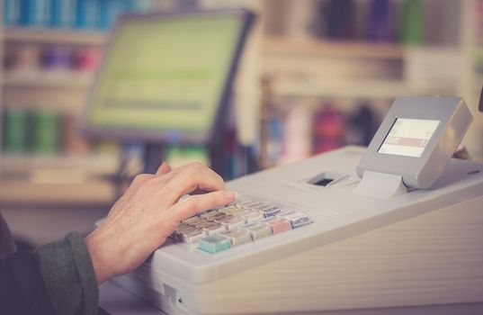 Cash register in a shop: Customer is paying purchase