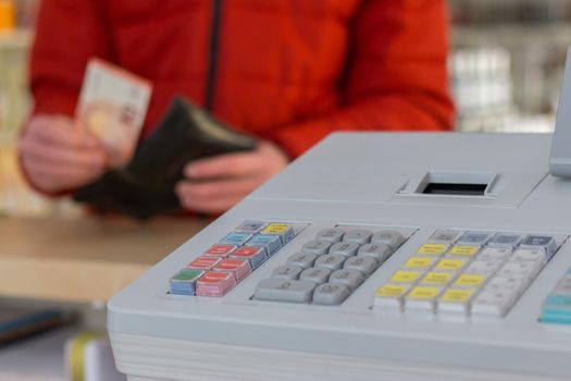 Cash register in a shop: Customer is paying purchase