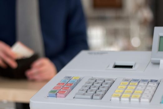 Cash register in a shop: Customer is paying purchase