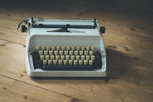 Vintage typewriter on a wooden desk, cutout