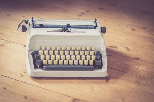Vintage typewriter on a wooden desk, cutout