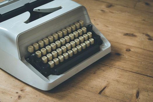 Vintage typewriter on a wooden desk, cutout