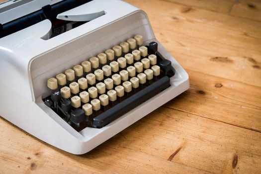 Vintage typewriter on a wooden desk, cutout