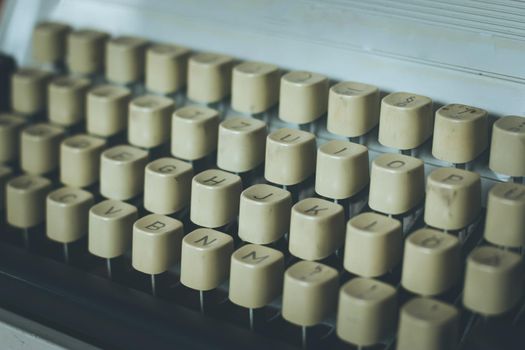 Vintage typewriter on a wooden desk, cutout