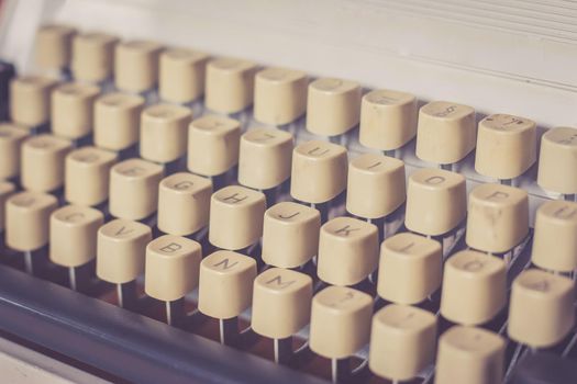Vintage typewriter on a wooden desk, cutout