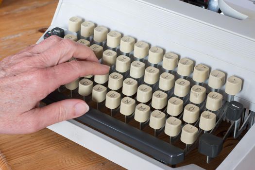 Vintage typewriter on a wooden desk, cutout