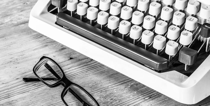 Vintage typewriter on a wooden desk, cutout