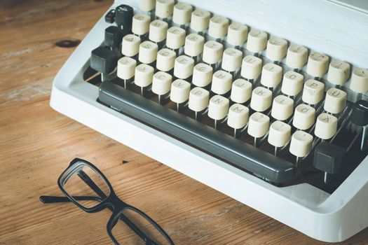 Vintage typewriter on a wooden desk, cutout