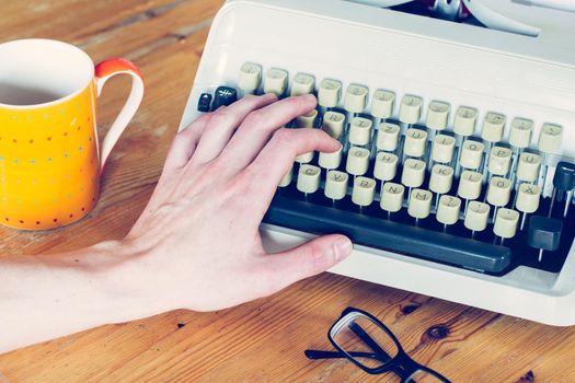 Vintage typewriter on a wooden desk, cutout