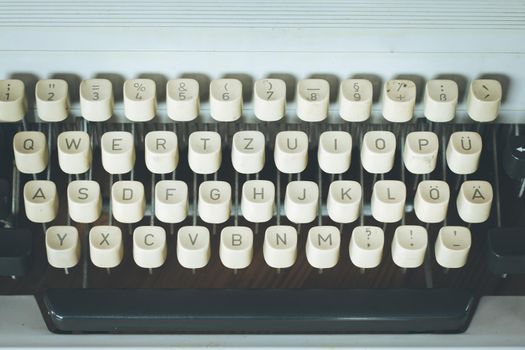 Vintage typewriter on a wooden desk, cutout