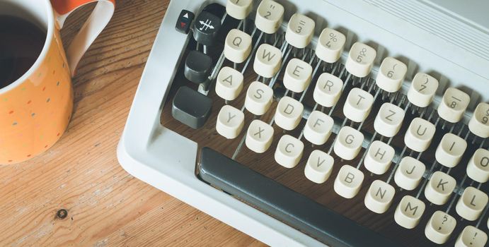 Vintage typewriter on a wooden desk, cutout