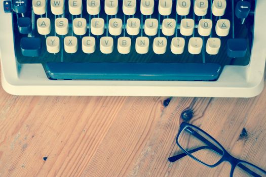 Vintage typewriter on a wooden desk, cutout