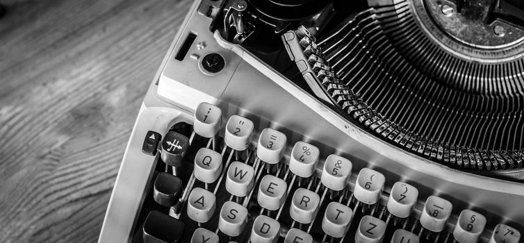 Vintage typewriter on a wooden desk, cutout