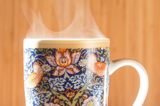 Steaming tea cup and sunlight, warm-up in winter