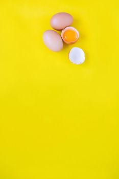 Closeup cracked brown eggs Buy from supermarket Placed on a yellow background.