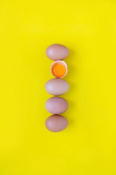 Closeup cracked brown eggs Buy from supermarket Placed side by side on a yellow background