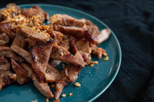 Grilled Pork Neck and Grilled Pork Intestine. Garnish with fried garlic. Local food in Thailand It is a popular food. You can find it at street food stores.