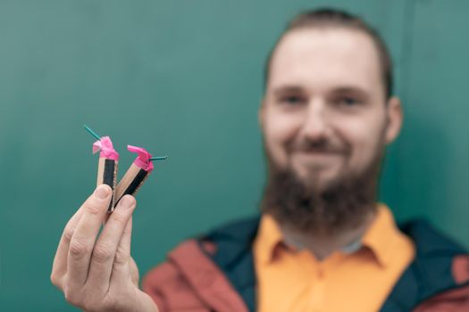 Happy Young Man Holding Firecrackers in his Hand. Bearded Guy Getting Ready for New Year Fun