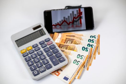 50 euro bills with calculator and graph on white background