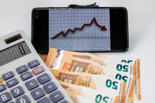 50 euro bills with calculator and graph on white background