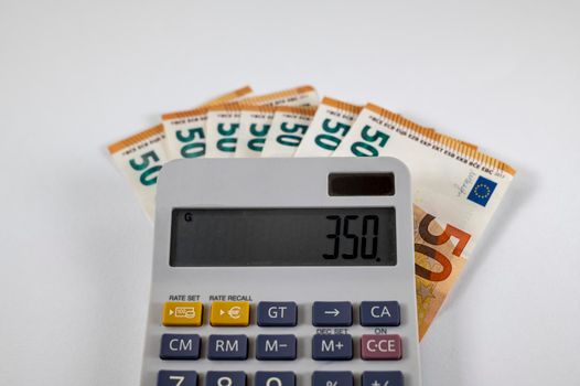 50 euro banknotes with calculator on white background