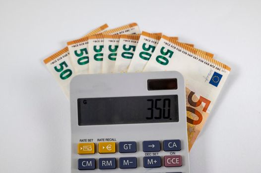 50 euro banknotes with calculator on white background